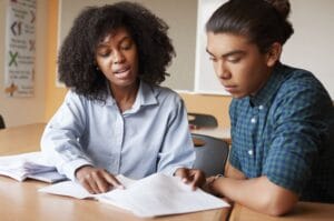 tutor teaching high school student