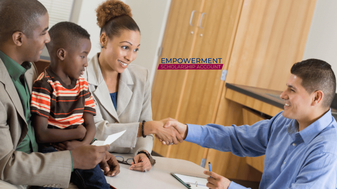A woman smiles and shakes hands with a man across a desk, while a man and a young boy sit beside her holding papers. The words Education Scholarship Trust Fund Program appear in the background.