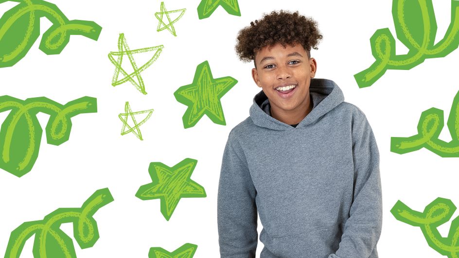 A smiling boy in a gray hoodie stands in front of a white background decorated with green stars and abstract green shapes.