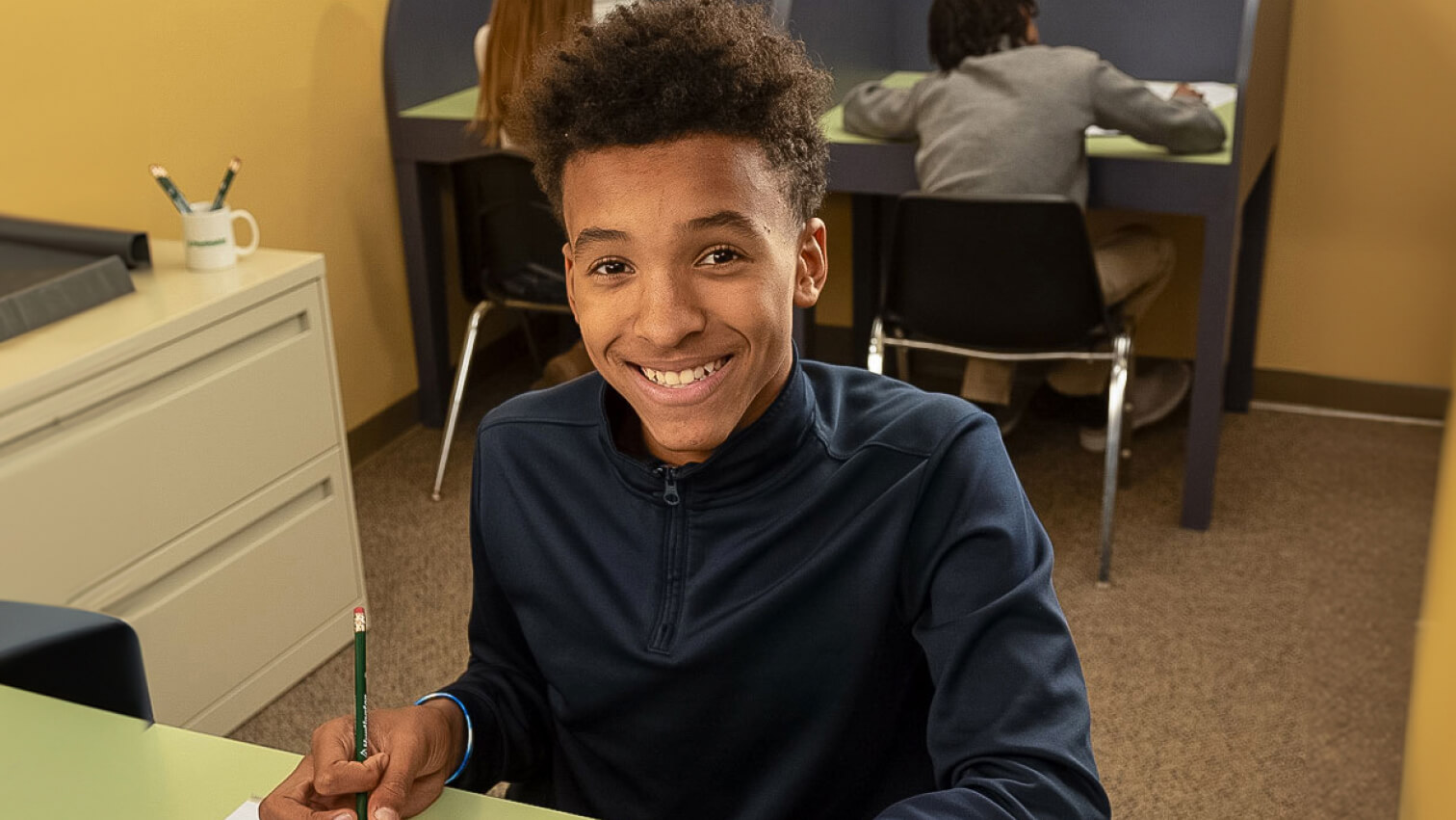 A student sitting at a desk for L-12 Writing Subject Tutoring at Huntington Learning Center